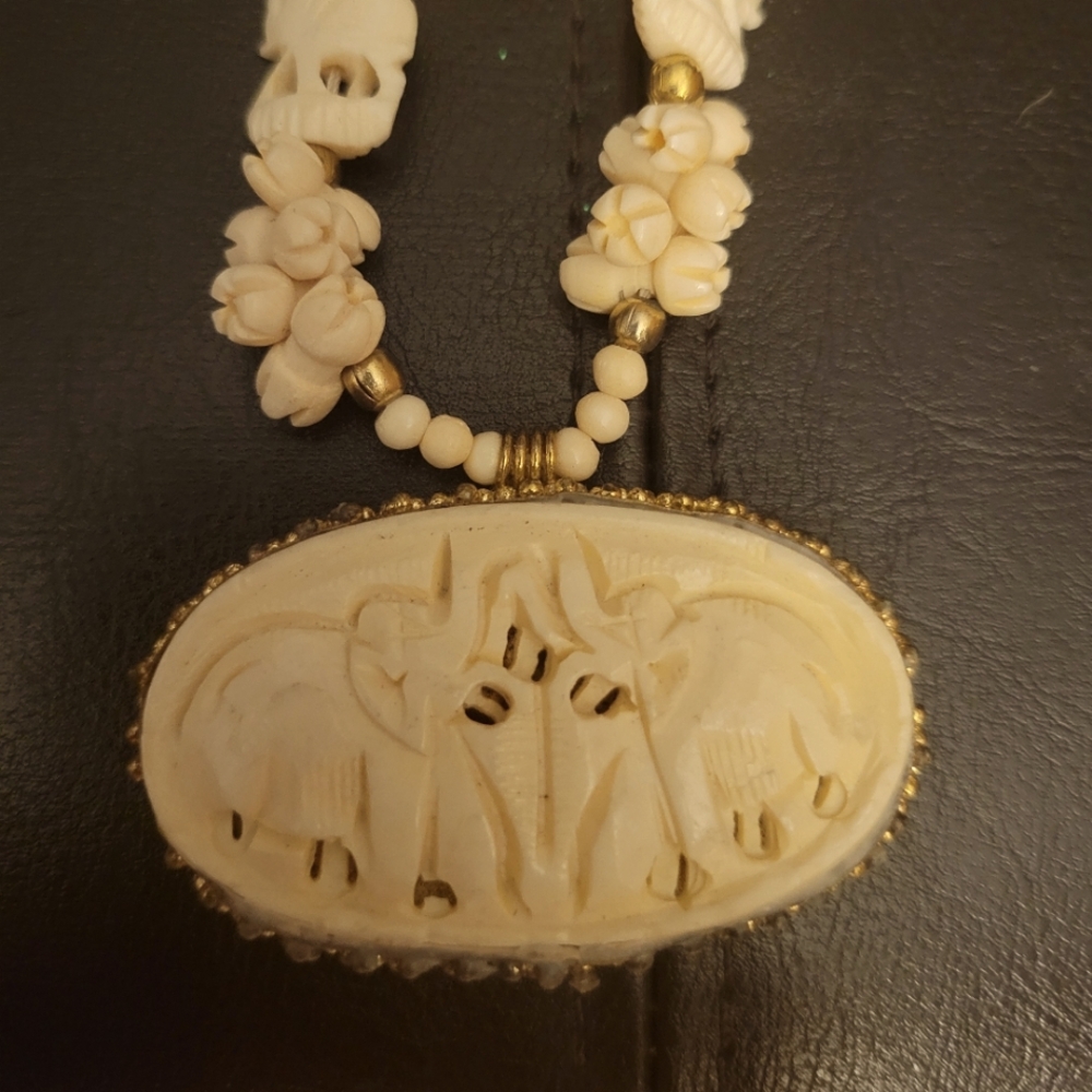 Carved Elephant Bone Nwcklace With Gold Accents.